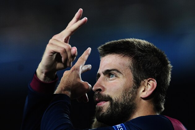 Barcelona's Gerard Pique, left, celebrates scoring against APOEL during the Champions League Group F soccer match between Barcelona and Apoel at the Camp Nou stadium in Barcelona, Spain, Wednesday, Sept. 17, 2014. (AP Photo/Manu Fernandez)