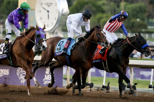 Jockey Martin Garcia, right, celebrates after riding Bayern to victory in the Breeders' Cup Classic horse race past Jockey Victor Espinoza on California Chrome, left, Jockey Jamie Spencer on Toast of New York at Santa Anita Park, Saturday, Nov. 1, 2014, in Arcadia, Calif.  (AP Photo/Jae C. Hong)