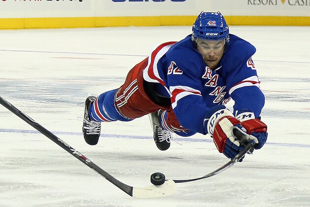 NEW YORK, NY - SEPTEMBER 29: Dylan McIlrath #42 of the New York Rangers dives to hit the puck during the game against the Philadelphia Flyers at Madison Square Garden on September 29, 2014 in New York City.  (Photo by Bruce Bennett/Getty Images)