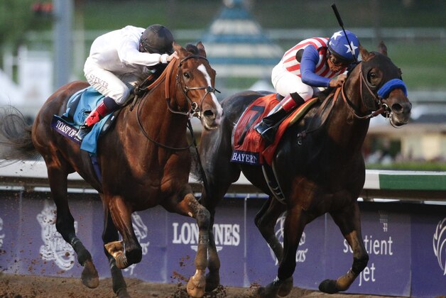 Jockey Martin Garcia rides Bayern, right, to victory in the Breeders' Cup Classic horse race past Jockey Jamie Spencer on Toast of New York at Santa Anita Park, Saturday, Nov. 1, 2014, in Arcadia, Calif. (AP Photo/Jae C. Hong)