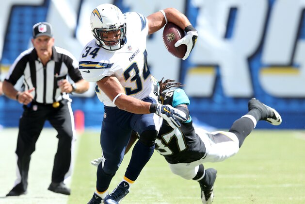 SAN DIEGO, CA - SEPTEMBER 28:  Running back Donald Brown #34 of the San Diego Chargers carries the ball against safety Johnathan Cyprien #37 of the Jacksonville Jaguars at Qualcomm Stadium on September 28, 2014 in San Diego, California.  (Photo by Stephen Dunn/Getty Images)