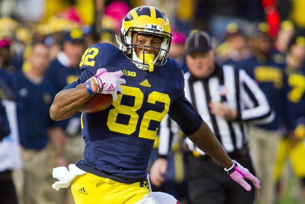 Michigan wide receiver Amara Darboh (82) makes a catch while defended by Indiana safety Mark Murphy, bottom, in the first quarter of an NCAA college football game in Ann Arbor, Mich., Saturday, Nov. 1, 2014. (AP Photo/Tony Ding)