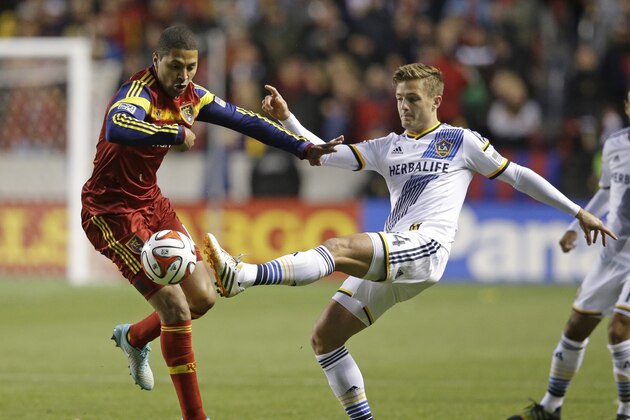 Real Salt Lake forward Alvaro Saborio, left, and Los Angeles Galaxy midfielder Robbie Rogers (14) battle for the ball in the first half during an MLS Western Conference semifinal, first leg playoff soccer match Saturday, Nov. 1, 2014, in Sandy, Utah. (AP Photo/Rick Bowmer)