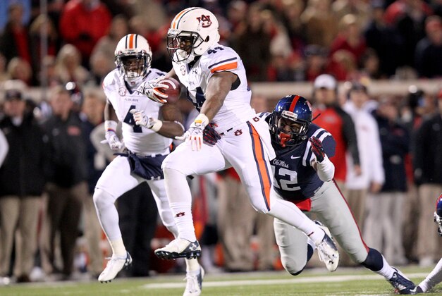 Nov 1, 2014; Oxford, MS, USA; Auburn Tigers running back Cameron Artis-Payne (44) rushes during the third quarter as Ole Miss Rebels defensive back Tony Conner (12) attempts a stop at Vaught-Hemingway Stadium. Mandatory Credit: Nelson Chenault-USA TODAY Sports