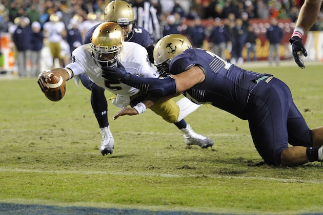 Notre Dame quarterback Everett Golson (5) dives for the end zone to score a touchdown against Navy safety Parrish Gaines (2) and others during the second half of an NCAA college football game, Saturday, Nov. 1, 2014, in Landover, Md. Notre Dame won 49-39. (AP Photo/Nick Wass)