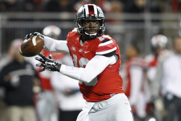 Ohio State quarterback J.T. Barrett drops back to pass against Illinois during the first quarter of an NCAA college football game Saturday, Nov. 1, 2014, in Columbus, Ohio. (AP Photo/Paul Vernon)