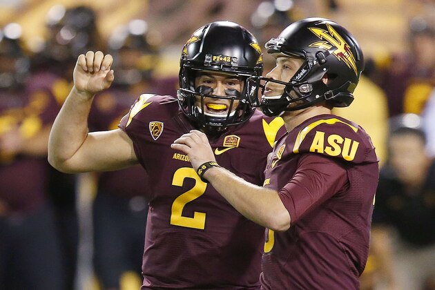 Arizona State's Zane Gonzalez, right, celebrates his game-winning field goal against Utah with teammate Mike Bercovici (2) in overtime of an NCAA college football game on Saturday, Nov. 1, 2014, in Tempe, Ariz.  Arizona State defeated the Utah 19-16 in overtime. (Photo/Ross D. Franklin)