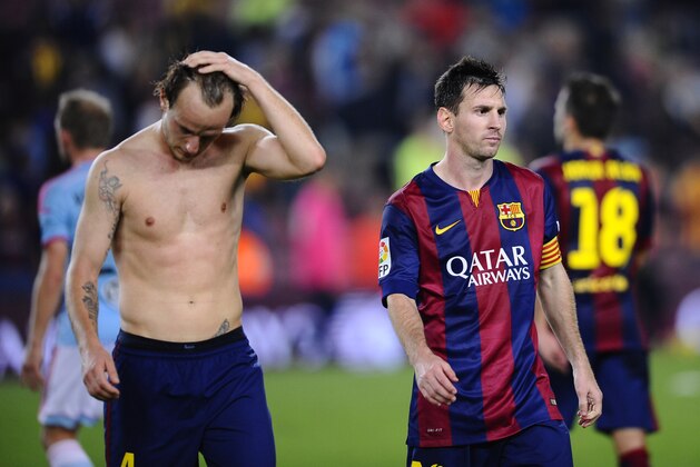 FC Barcelona's Lionel Messi, from Argentina, right, and Ivan Rakitic,react at the end of the match during a Spanish La Liga soccer match against Celta de Vigo at the Camp Nou stadium in Barcelona, Spain, Saturday, Nov. 1, 2014. (AP Photo/Manu Fernandez)