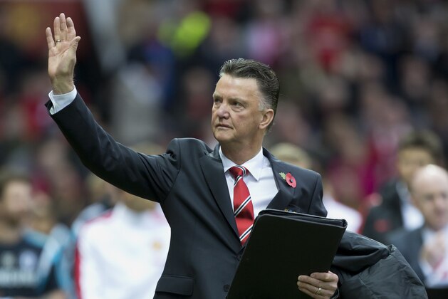 Manchester United's manager Louis van Gaal waves as he walks down the touchline before his team's English Premier League soccer match against Chelsea at Old Trafford Stadium, Manchester, England, Sunday Oct. 26, 2014. (AP Photo/Jon Super)
