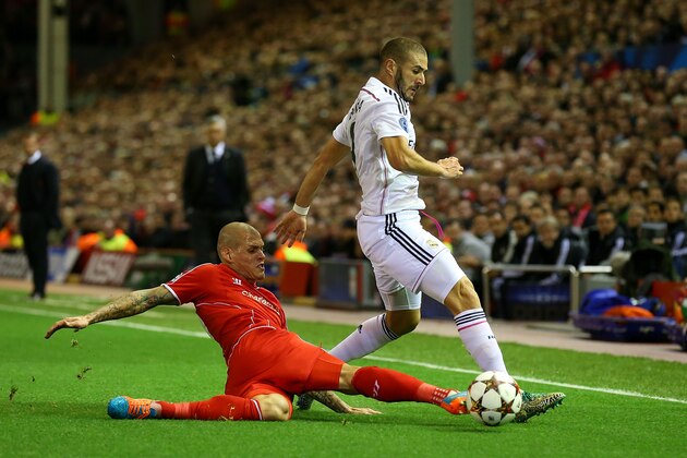 LIVERPOOL, ENGLAND - OCTOBER 22:  Martin Skrtel of Liverpool tackles Karim Benzema of Real Madrid during the UEFA Champions League Group B match between Liverpool and Real Madrid CF on October 22, 2014 in Liverpool, United Kingdom.  (Photo by Alex Livesey/Getty Images)