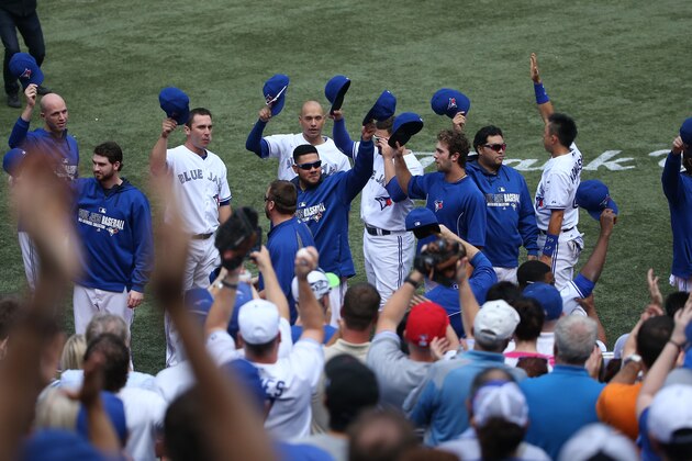 TORONTO, CANADA - SEPTEMBER 28: Toronto Blue Jays palyers salute the fans in the fourth inning during MLB game action against the Baltimore Orioles on September 28, 2014 at Rogers Centre in Toronto, Ontario, Canada. (Photo by Tom Szczerbowski/Getty Images)