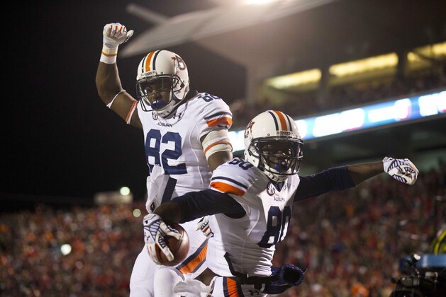 Auburn wide receiver Melvin Ray (82) and Auburn wide receiver Marcus Davis (80) celebrate after Davis scored a touchdown during the second half of an NCAA college football game against Mississippi, Saturday, Nov. 1, 2014, in Oxford, Miss. (AP Photo/Brynn Anderson)