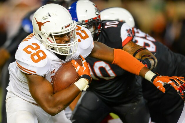 LUBBOCK, TX - NOVEMBER 1: Malcolm Brown #28 of the Texas Longhorns runs the ball against the Texas Tech Red Raiders on November 1, 2014 at Jones AT&T Stadium in Lubbock, Texas. Texas won the game 34-13 .(Photo by John Weast/Getty Images)