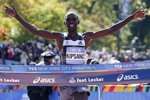 Wilson Kipsang of Kenya celebrates as he hits the tape to win the men's division of the the 44th annual New York City Marathon in New York, Sunday, Nov. 2, 2014. Kipsang won in an unofficial time of 2 hours, 10 minutes, 59 seconds. (AP Photo/Kathy Willens)