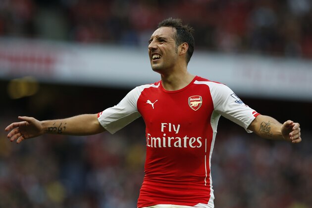 Arsenal's Santi Cazorla reacts in frustration at the slow pace of a throw in, during the English Premier League soccer match between Arsenal and Hull City at the Emirates stadium in London Saturday, Oct.18,  2014. (AP Photo/Alastair Grant)