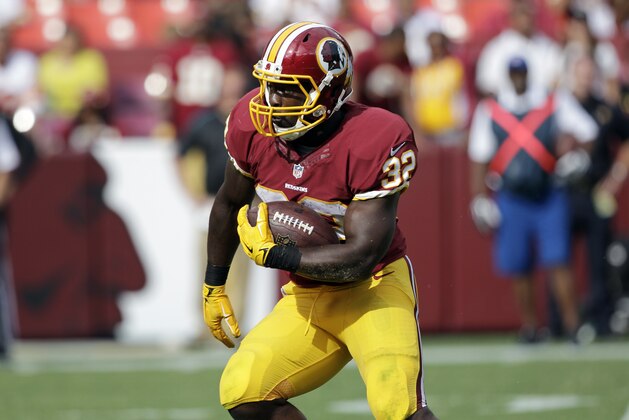 Washington Redskins running back Silas Redd (32) runs with the ball during the second half of an NFL football game against the Jacksonville Jaguars Sunday, Sept. 14, 2014, in Landover, Md. The Redskins won 41-10. (AP Photo/Mark E. Tenally)