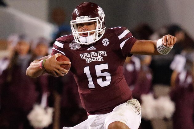 Nov 1, 2014; Starkville, MS, USA; Mississippi State Bulldogs quarterback Dak Prescott (15) hurdles running back Josh Robinson (13) during the game against the Arkansas Razorbacks at Davis Wade Stadium.  The Bulldogs defeat the Razorbacks 17-10. Mandatory Credit: Marvin Gentry-USA TODAY Sports