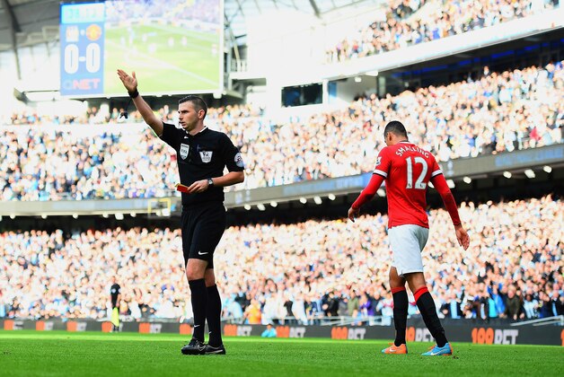 MANCHESTER, ENGLAND - NOVEMBER 02:  Chris Smalling of Manchester United leaves the field after receiving a red card by Referee Michael Oliver during the Barclays Premier League match between Manchester City and Manchester United at Etihad Stadium on November 2, 2014 in Manchester, England.  (Photo by Laurence Griffiths/Getty Images)