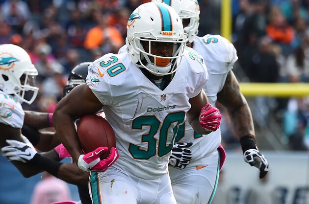 Oct 19, 2014; Chicago, IL, USA; Miami Dolphins running back Daniel Thomas (30) rushes the ball against the Chicago Bears during the second half at Soldier Field. Miami Dolphins defeat the Chicago Bears 27-14. Mandatory Credit: Mike DiNovo-USA TODAY Sports
