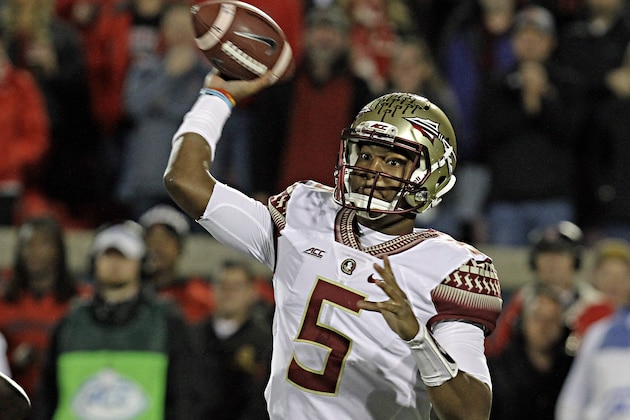 Florida State quarterback Jameis Winston (5) looks to pass in the first half of a NCAA college football game against Louisville in Louisville, Ky., Thursday, Oct. 30, 2014. (AP Photo/Garry Jones)