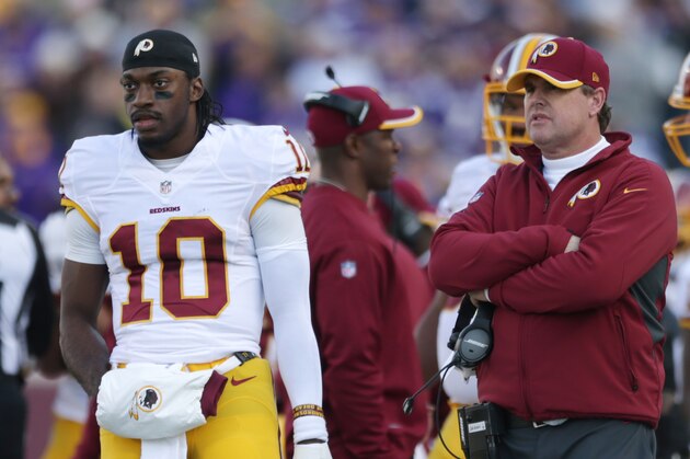 Washington Redskins quarterback Robert Griffin III, left, stands on the sidelines with head coach Jay Gruden, right, during the first half of an NFL football game against the Minnesota Vikings, Sunday, Nov. 2, 2014, in Minneapolis. The Vikings won 29-26. (AP Photo/Jim Mone)