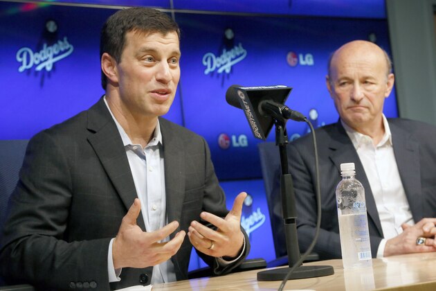 Andrew Friedman, left, a 37-year-old former Wall Street analyst, speaks after being introduced by Dodgers president and CEO Stan Kasten, right, as the new Los Angeles Dodger president of baseball operations at Dodger Stadium in Los Angeles, Friday, Oct. 17, 2014. (AP Photo/Nick Ut)