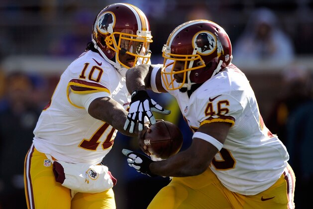 MINNEAPOLIS, MN - NOVEMBER 2: Robert Griffin III #10 of the Washington Redskins hands off the ball to teammate Alfred Morris #46 during the second quarter of the game against the Minnesota Vikings on November 2, 2014 at TCF Bank Stadium in Minneapolis, Minnesota. (Photo by Hannah Foslien/Getty Images)