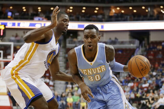 Denver Nuggets forward Quincy Miller, right, drives past Golden State Warriors forward Harrison Barnes during the second half of a preseason NBA basketball game, Thursday, Oct. 16, 2014, in Des Moines, Iowa. Golden State won 104-101. (AP Photo/Charlie Neibergall)