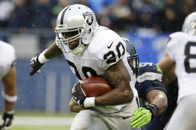 Oakland Raiders running back Darren McFadden (20) is tackled by Seattle Seahawks linebacker L.J. Fort in the second half of an NFL football game, Sunday, Nov. 2, 2014, in Seattle. (AP Photo/Elaine Thompson)