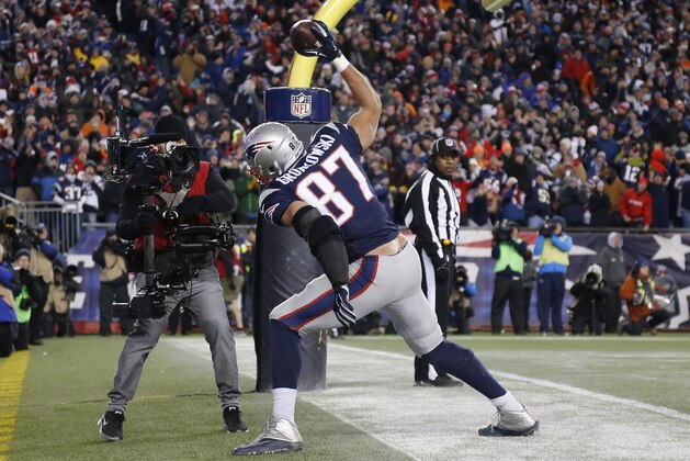 New England Patriots tight end Rob Gronkowski celebrates in the end zone after catching a touchdown pass from quarterback Tom Brady in the second half of an NFL football game against the Denver Broncos on Sunday, Nov. 2, 2014, in Foxborough, Mass. (AP Photo/Elise Amendola)