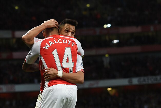 Arsenal’s Alexis Sanchez, right, celebrates scoring his side's third goal with teammate Theo Walcott during their English Premier League soccer match against Burnley at the Emirates stadium, London, Saturday, Nov. 1, 2014. (AP Photo/Tim Ireland)
