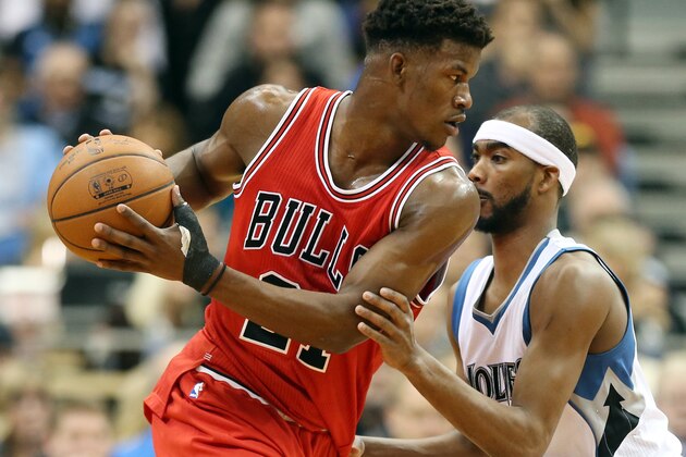 Chicago Bulls' Jimmy Butler, left, drives on Minnesota Timberwolves' Corey Brewer in the first quarter of an NBA basketball game, Saturday, Nov. 1, 2014, in Minneapolis. (AP Photo/Jim Mone)