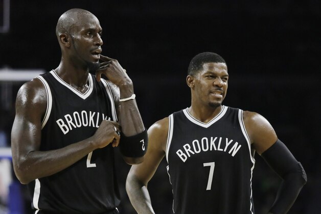 Brookyn Net's Kevin Garnett (2) and Joe Johnson (7) look at a NBA official after a foul was called on the nets during the second half of an NBA basketball game against the Detroit Pistons Saturday, Nov. 1, 2014, in Auburn Hills, Mich. The Nets defeated the Pistons 102-90.(AP Photo/Duane Burleson)