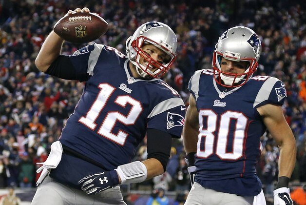 New England Patriots quarterback Tom Brady (12) celebrates with wide receiver Danny Amendola (80) in the first half of an NFL football game against the Denver Broncos on Sunday, Nov. 2, 2014, in Foxborough, Mass. (AP Photo/Elise Amendola)