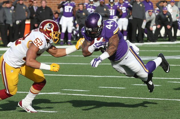 Minnesota Vikings running back Matt Asiata, right, scores on a 7-yard touchdown run in front of Washington Redskins inside linebacker Keenan Robinson (52) during the second half of an NFL football game, Sunday, Nov. 2, 2014, in Minneapolis. (AP Photo/Jim Mone)