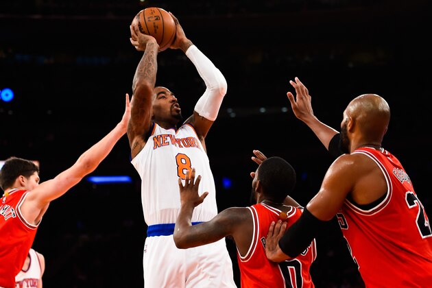 NEW YORK, NY - OCTOBER 29: J.R. Smith #8 of the New York Knicks shoots over Aaron Brooks #0 of the Chicago Bulls in the fourth quarter during a game at Madison Square Garden on October 29, 2014 in New York City. NOTE TO USER: User expressly acknowledges and agrees that, by downloading and/or using this photograph, user is consenting to the terms and conditions of the Getty Images License Agreement.  (Photo by Alex Goodlett/Getty Images)