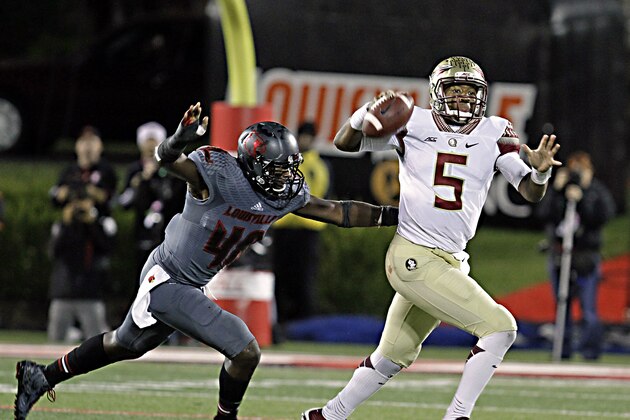 Florida State quarterback Jameis Winston (5) gets off a pass despite the efforts of Louisville defensive end Delontrez Mount (48) in the second half of their NCAA college football game in Louisville, Ky., Thursday, Oct. 30, 2014. Winston led No. 2 Florida State to a 42-31 come-from-behind victory over Louisville. (AP Photo/Garry Jones)