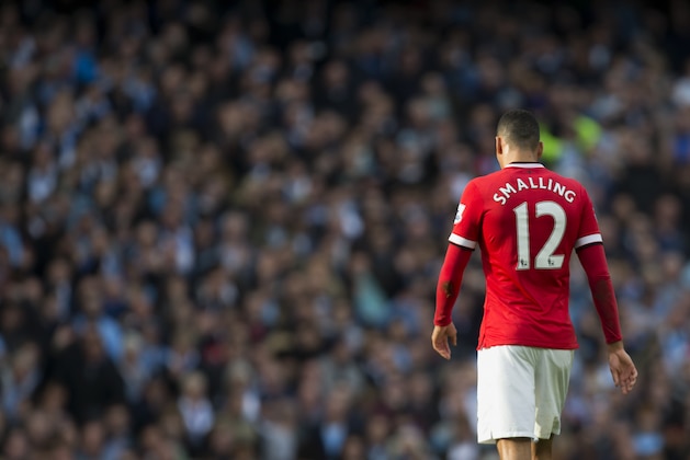 Manchester United's Chris Smalling makes his way from the pitch after being is shown a red card by referee Michael Oliver during his team's English Premier League soccer match against Manchester City at the Etihad Stadium, Manchester, England, Sunday Nov. 2, 2014. (AP Photo/Jon Super)
