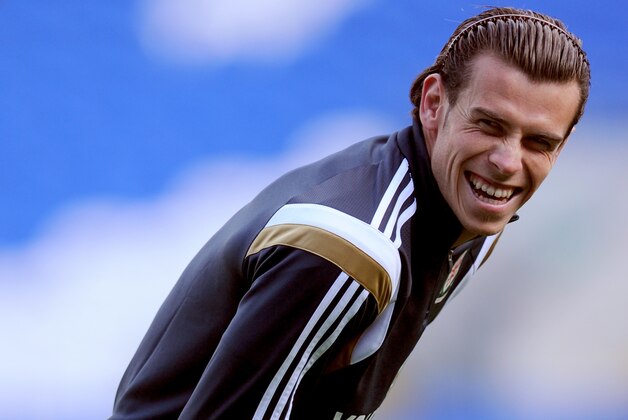 CARDIFF, WALES - OCTOBER 09:  Wales player Gareth Bale (r) shares a joke with team mates during Wales training ahead of their UEFA 2016 qualifier against Bosnia-Herzegovina  at Cardiff City Stadium on October 9, 2014 in Cardiff, Wales.  (Photo by Stu Forster/Getty Images)