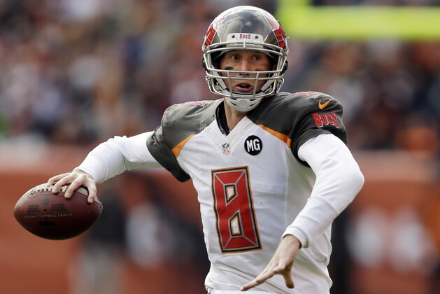Tampa Bay Buccaneers quarterback Mike Glennon throws on the run in the first quarter of an NFL football game against the Cleveland Browns Sunday, Nov. 2, 2014, in Cleveland. (AP Photo/Tony Dejak)