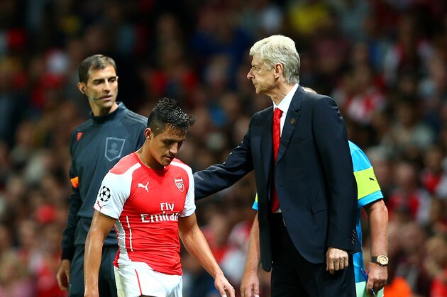 LONDON, ENGLAND - OCTOBER 01:  Arsene Wenger, manager of Arsenal pats Alexis Sanchez of Arsenal on the back as he is substituted for David Ospina after Wojciech Szczesny received a red card during the UEFA Champions League group D match between Arsenal FC and Galatasaray AS at Emirates Stadium on October 1, 2014 in London, United Kingdom.  (Photo by Paul Gilham/Getty Images)