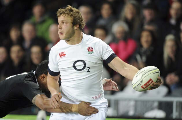 England’s Joe Launchbury passes the ball in field in a New Zealand tackle in the second international rugby test match at Forsyth Barr Stadium in Dunedin, New Zealand, Saturday, June 14, 2014.(AP Photo/SNPA, Ross Setford) NEW ZEALAND OUT