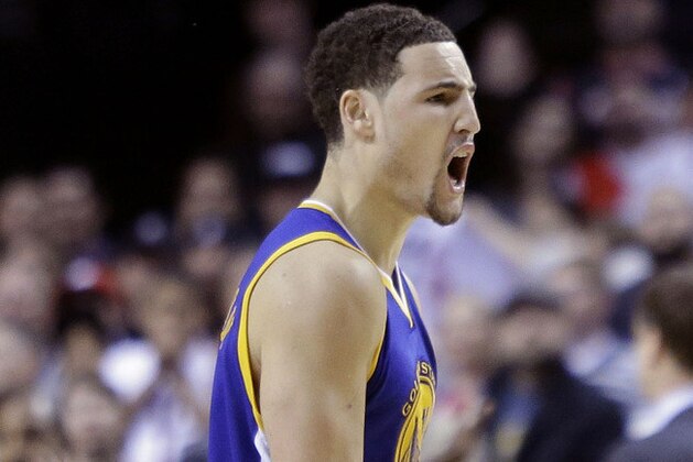 Golden State Warriors guard Klay Thompson reacts after sinking a basket to take the lead late in the second half of an NBA basketball game against the Portland Trail Blazers in Portland, Ore., Sunday, Nov. 2, 2014.  Thompson led the Warriors in scoring with 29 points as they beat the Trail Blazers 95-90. (AP Photo/Don Ryan)