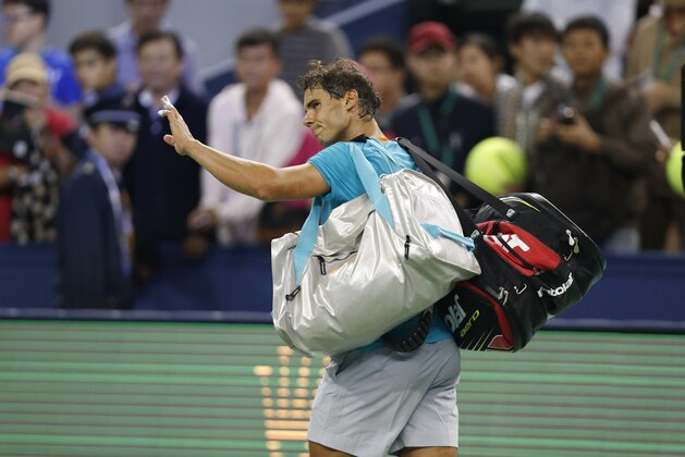 Rafael Nadal of Spain waves after being defeated by Feliciano Lopez of Spain in their men's singles second round match at the Shanghai Masters Tennis Tournament in Shanghai, China, Wednesday, Oct. 8, 2014.  (AP Photo/Vincent Thian)