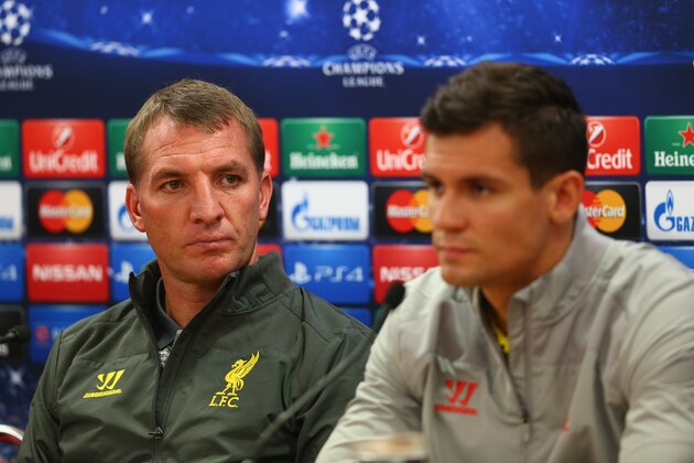 LIVERPOOL, ENGLAND - SEPTEMBER 15:  Liverpool manager Brendan Rodgers deep in thought whilst sitting next to his defender Dejan Lovren during a press conference ahead of their UEFA Champions League group B match against PFC Ludogorets on September 15, 2014 in Liverpool, United Kingdom.  (Photo by Clive Brunskill/Getty Images)