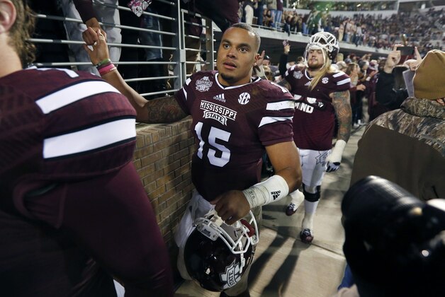 Mississippi State quarterback Dak Prescott (15) thanks fans following their victory over Arkansas in their NCAA college football game in Starkville, Miss., Saturday, Nov. 1, 2014. No. 1 Mississippi State won 17-10. (AP Photo/Rogelio V. Solis)