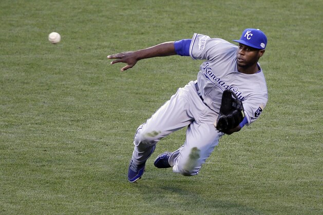 Kansas City Royals' Lorenzo Cain makes a diving catch on a ball hit by San Francisco Giants' Travis Ishikawa during the second inning of Game 3 of baseball's World Series Friday, Oct. 24, 2014, in San Francisco. (AP Photo/Eric Risberg)