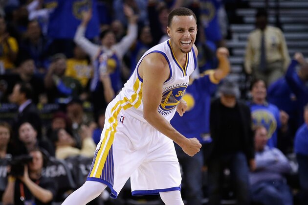 OAKLAND, CA - NOVEMBER 01:  Stephen Curry #30 of the Golden State Warriors reacts after he threw a long down court assist to Klay Thompson #11 who made a three-point basket against the Los Angeles Lakers at ORACLE Arena on November 1, 2014 in Oakland, California. NOTE TO USER: User expressly acknowledges and agrees that, by downloading and or using this photograph, User is consenting to the terms and conditions of the Getty Images License Agreement.  (Photo by Ezra Shaw/Getty Images)