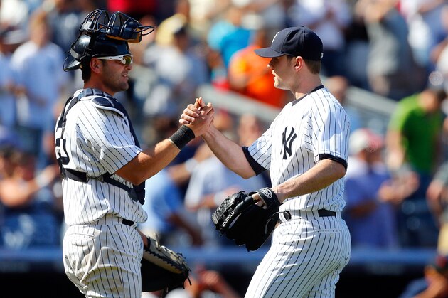 NEW YORK, NY - AUGUST 07:  David Robertson #30 (R) and Francisco Cervelli #29 of the New York Yankees celebrate after defeating the Detroit Tigers against th at Yankee Stadium on August 7, 2014 in the Bronx borough of New York City.  (Photo by Jim McIsaac/Getty Images)