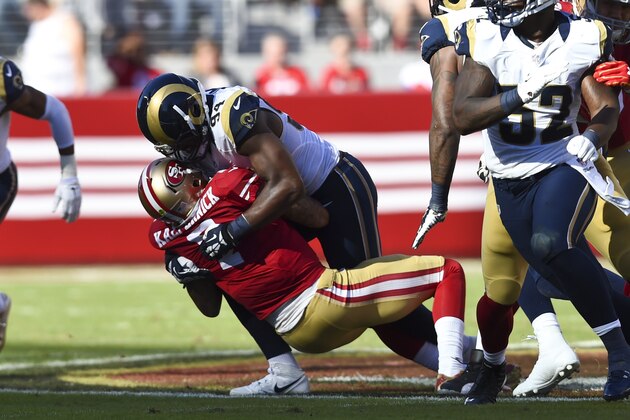 SANTA CLARA, CA - NOVEMBER 02: Colin Kaepernick #7 of the San Francisco 49ers is sacked by Robert Quinn #94 of the St. Louis Rams during the second quarter at Levi's Stadium on November 2, 2014 in Santa Clara, California.  (Photo by Thearon W. Henderson/Getty Images)